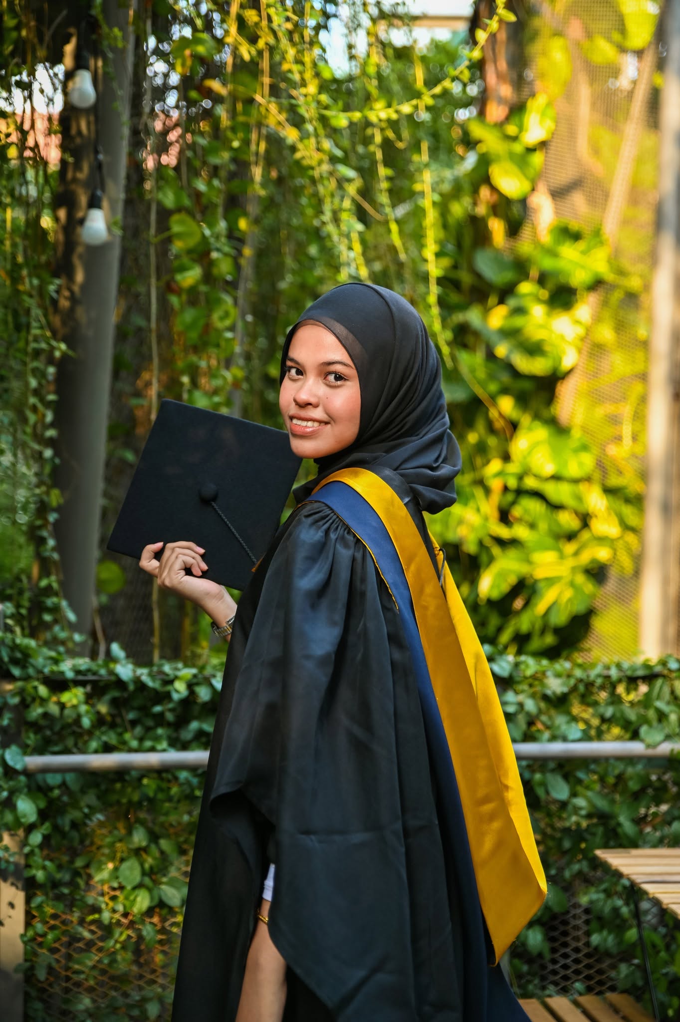 Graduates in gowns celebrating together on campus