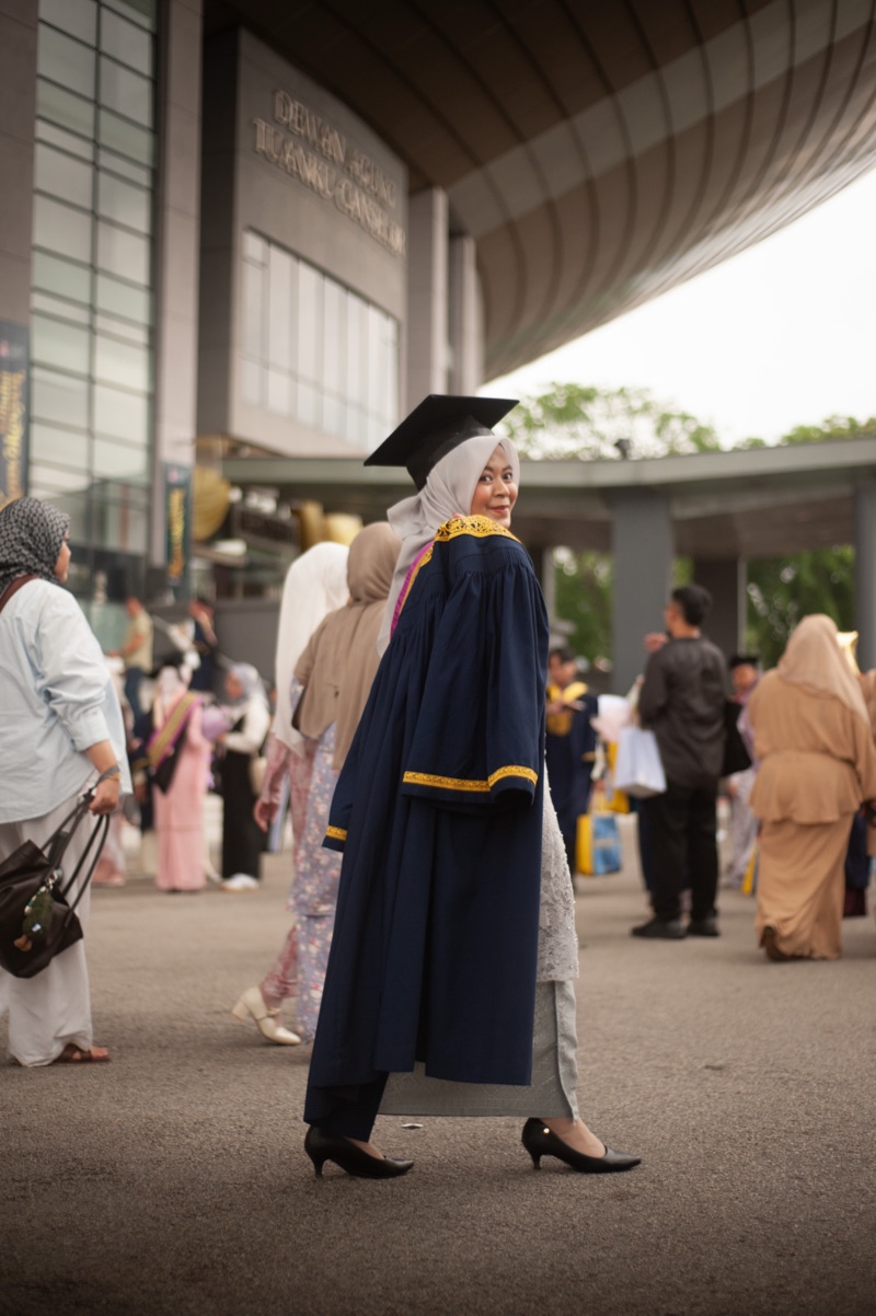 Graduates gathered on a campus staircase