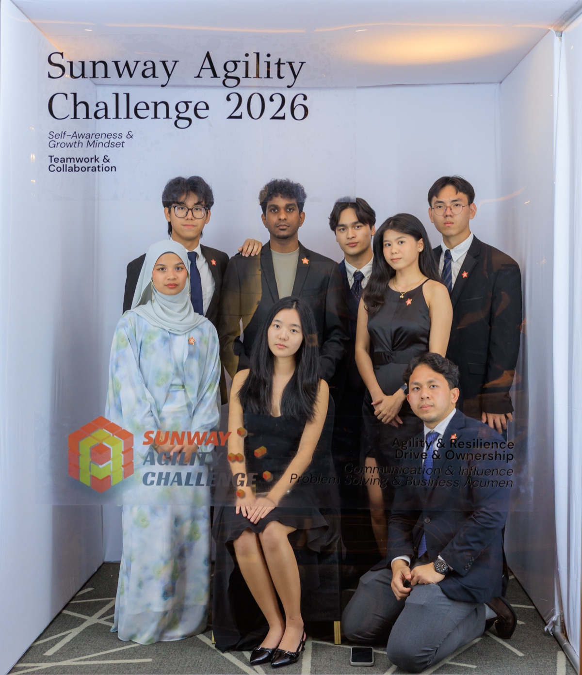 Eight guests in formal dress posing in the magazine booth