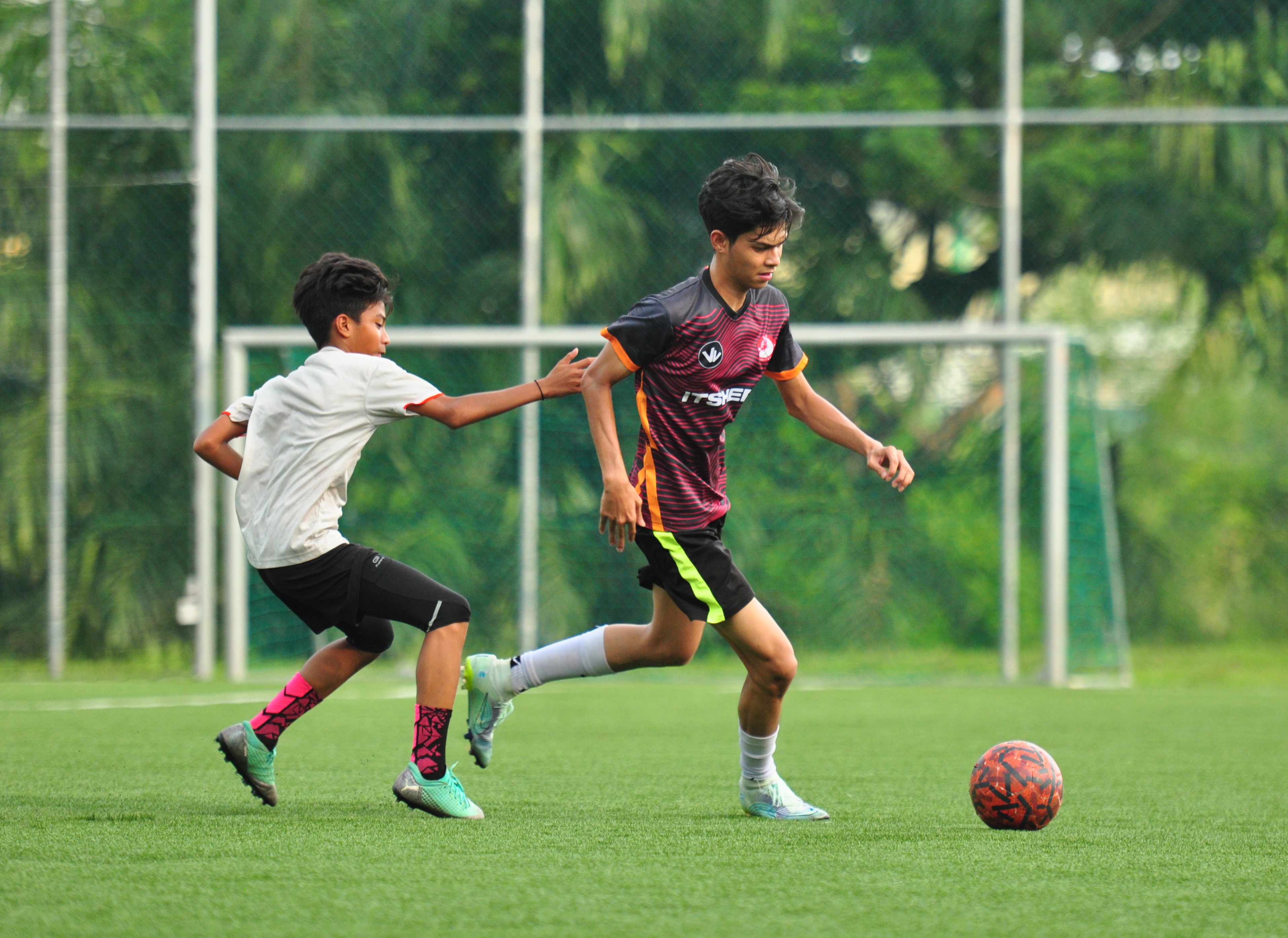 Sideline action: player on the ball, defender closing in